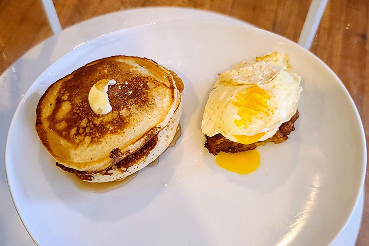 triple stack of pancakes, fried chicken, and easy egg